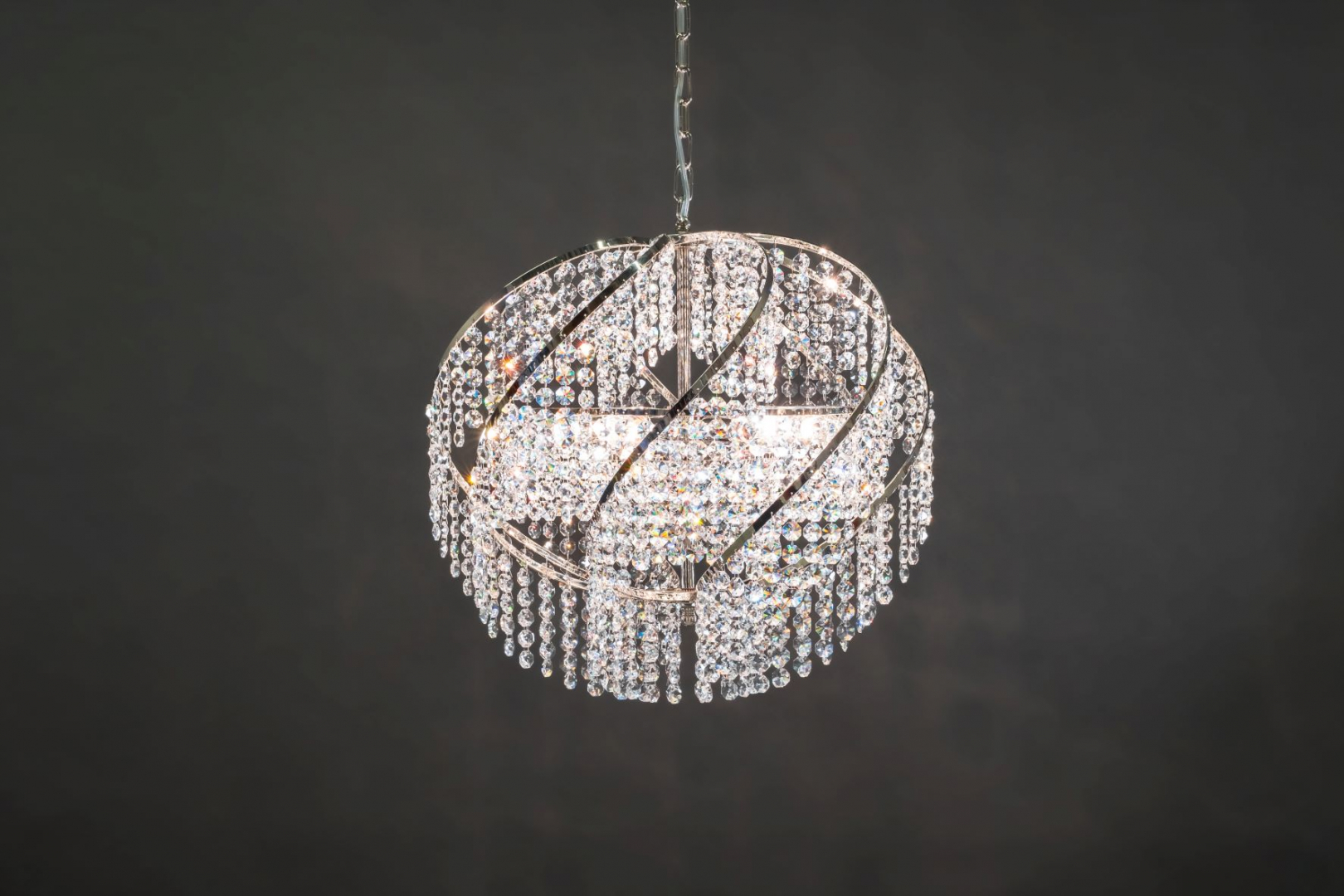 A Chandelier Pallo 1050 "ball" made from genuine crystals. This crystal lamp attracts attention and illuminates the room.